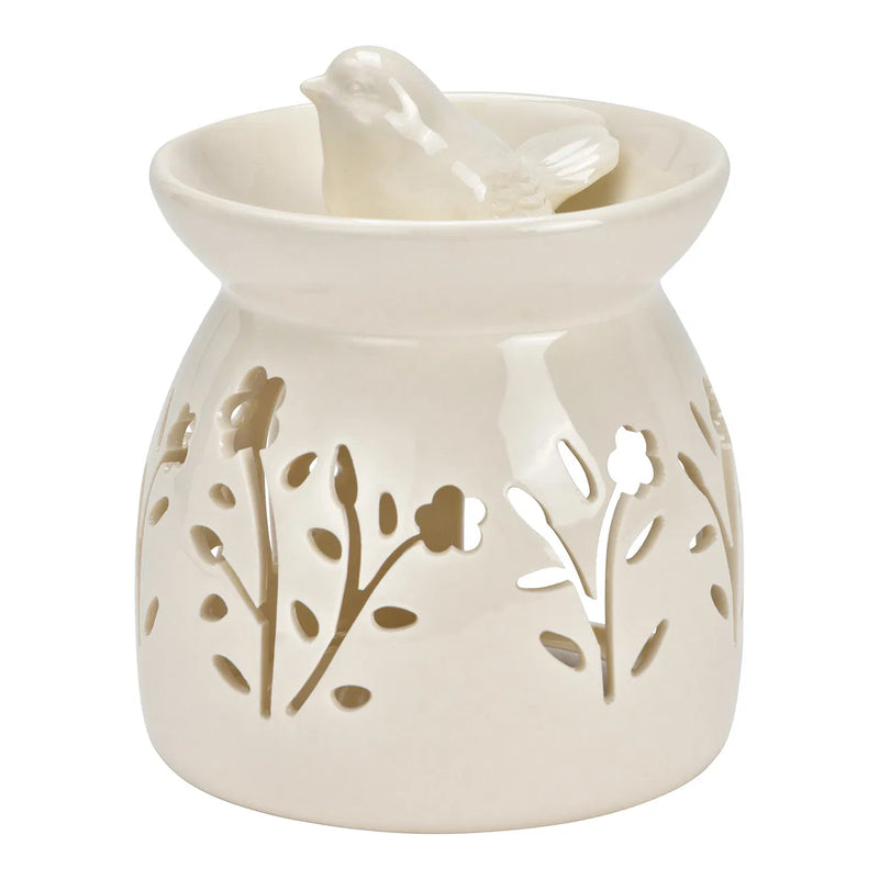 Brûle-parfum en céramique blanche ajourée à motifs floraux surmonté d'un oiseau décoratif