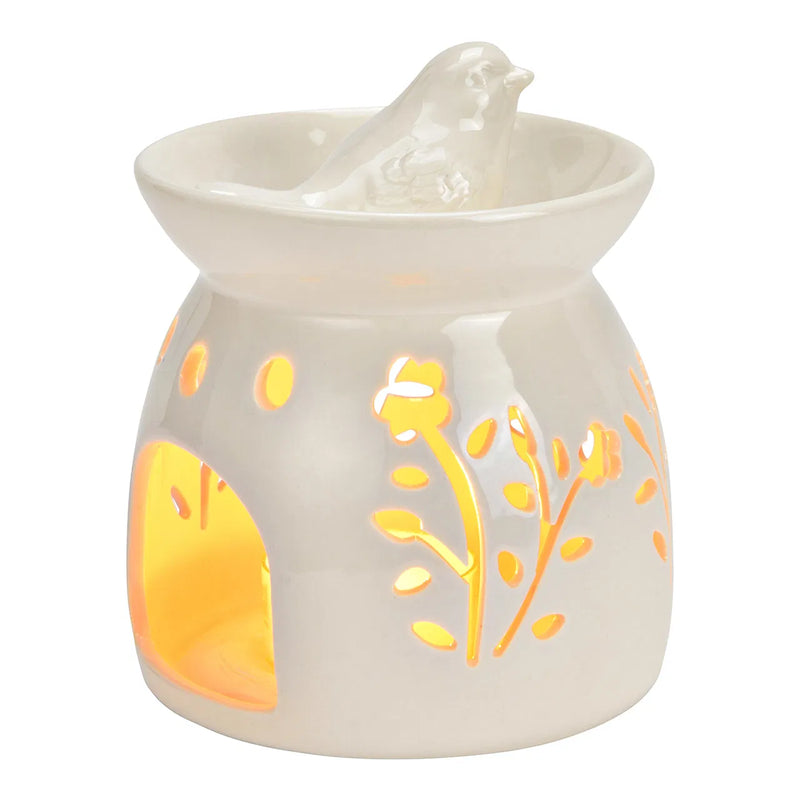 Brûle-parfum en céramique blanche ajourée à motifs floraux surmonté d'un oiseau décoratif