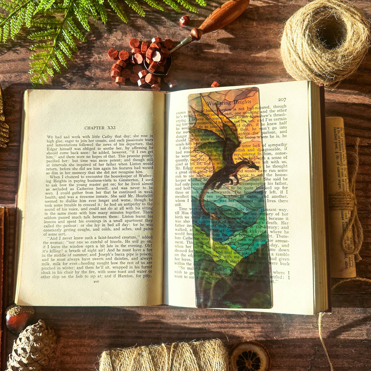 Marque-page transparent effet vitrail avec un dragon dominant un paysage montagneux