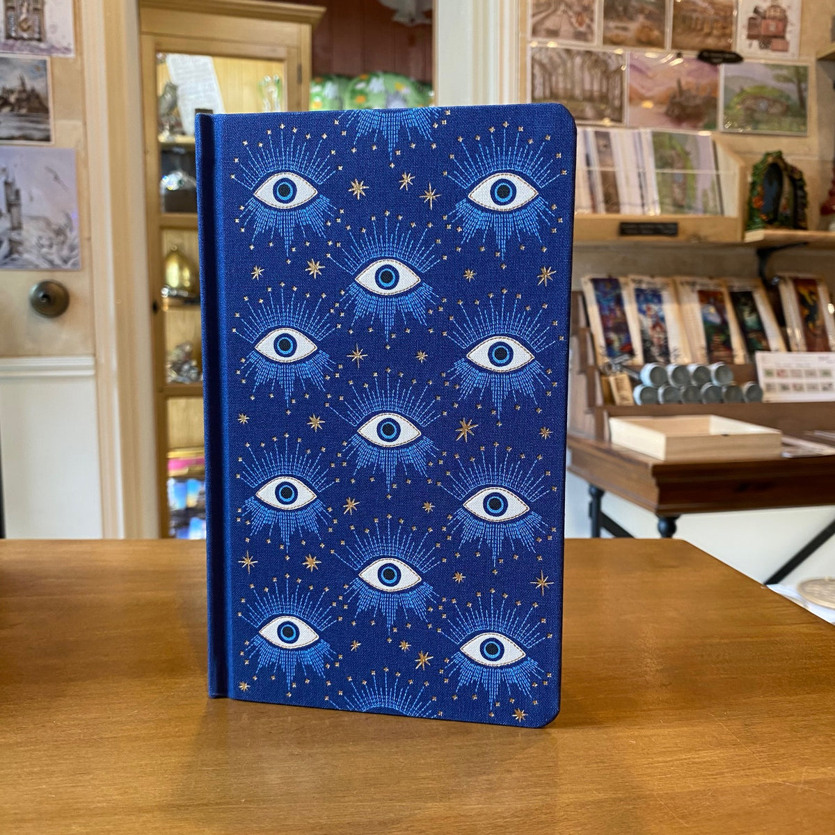 Carnet relié Designworks Ink Starry Eyed, couverture tissu bleu profond aux yeux mystiques dorés