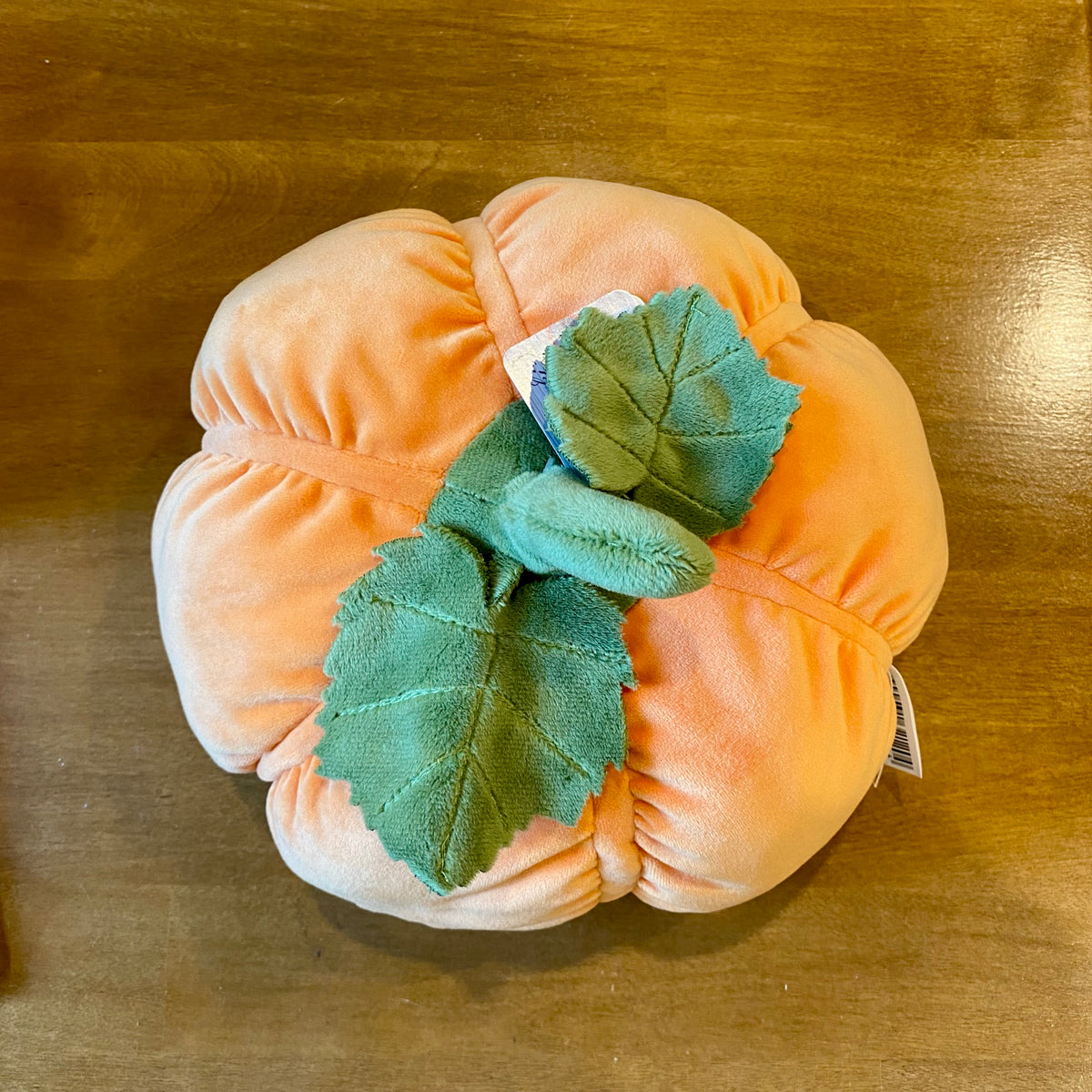 Peluche citrouille orange Bukowski de 25 cm avec sourire brodé et feuilles en tissu vert