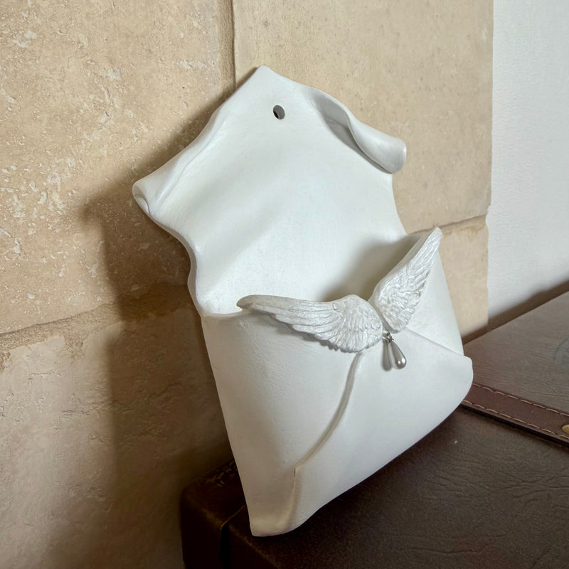 Enveloppe murale artisanale en argile ornée d'ailes d'ange irisées et d'une perle en forme de goutte