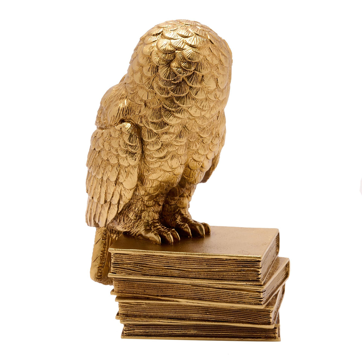 Figurine Harry Potter d'Hedwige perchée sur une pile de livres anciens, finition dorée