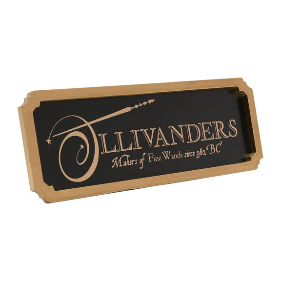 Enseigne murale Harry Potter Ollivanders en métal noir avec bordure dorée en bois