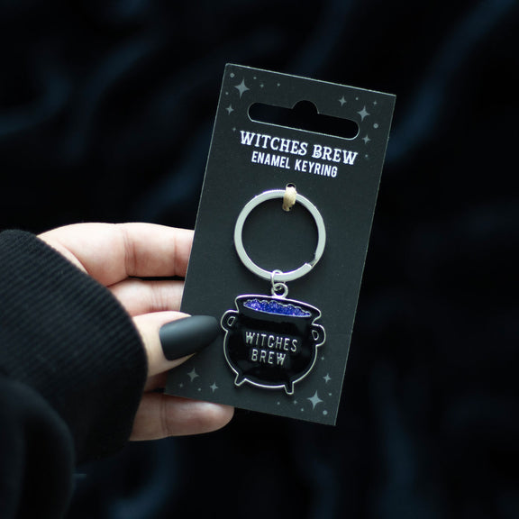 Porte-clés chaudron Witches Brew en métal émaillé noir avec potion violette pailletée
