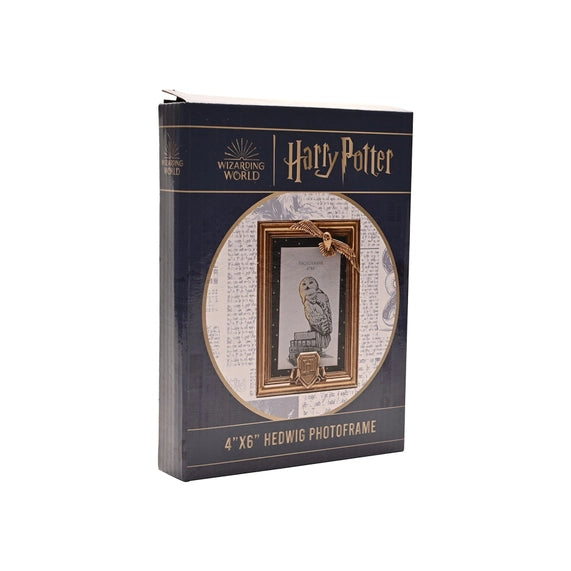 Cadre photo Harry Potter en résine dorée avec Hedwige en vol et blason de Poudlard