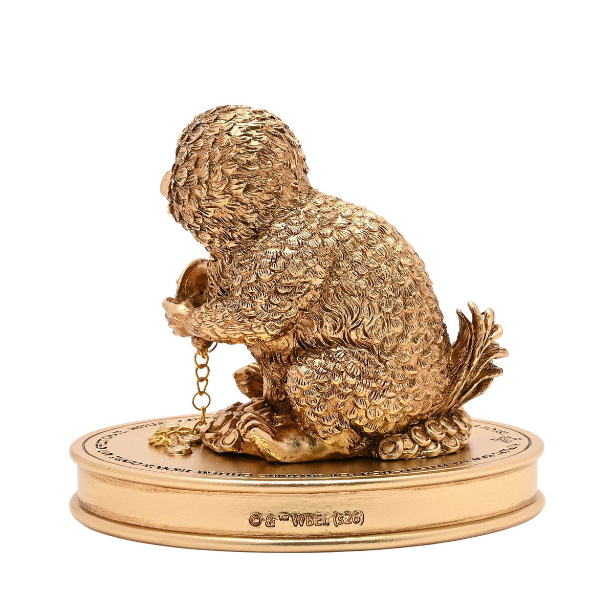 Figurine Harry Potter du Niffleur serrant une chaîne dorée sur un socle parsemé de trésors