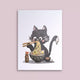 Carte postale Loeff Création, chat noir dégustant un bol de ramen avec des baguettes