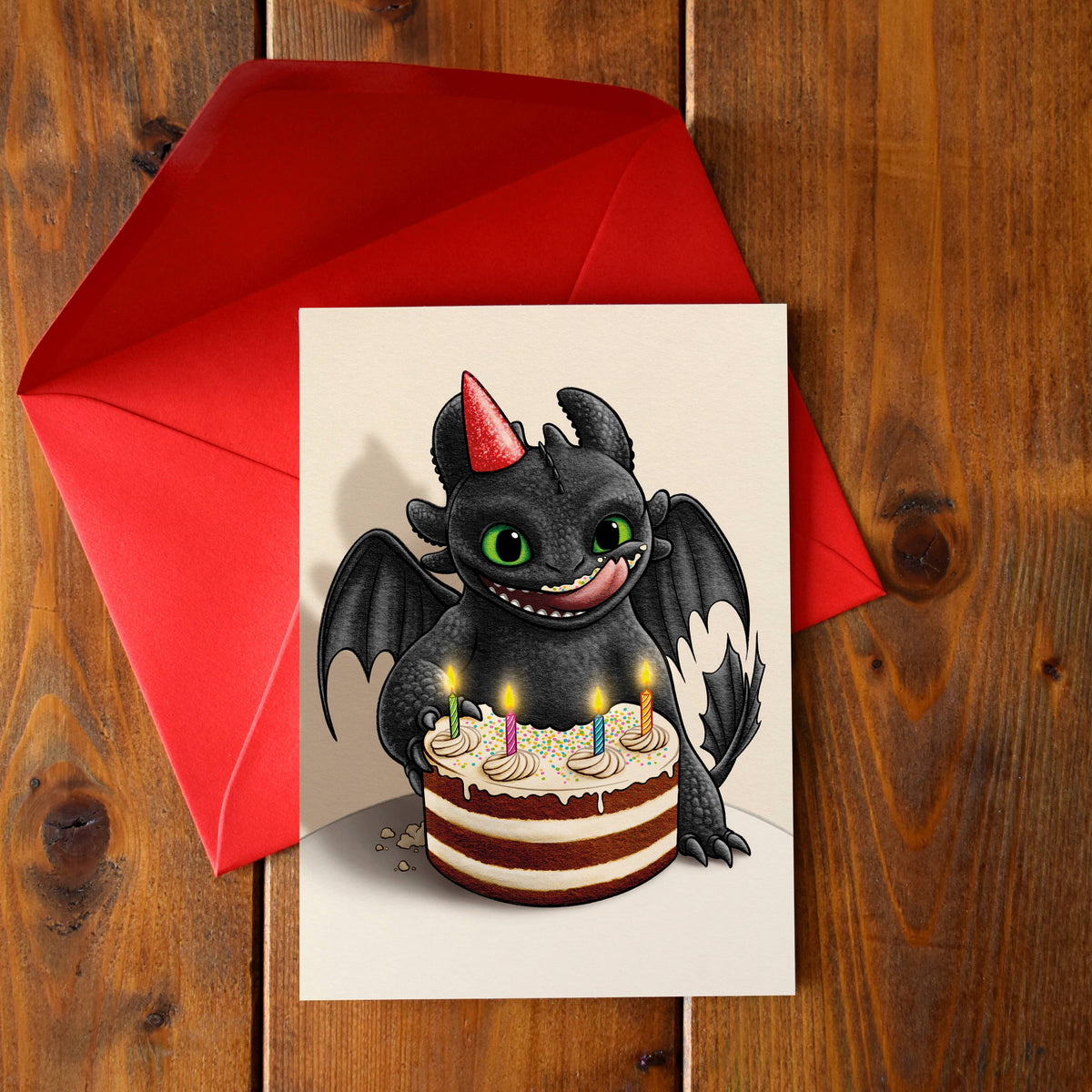 Carte d'anniversaire illustrée d'un petit dragon à chapeau de fête devant un gâteau coloré