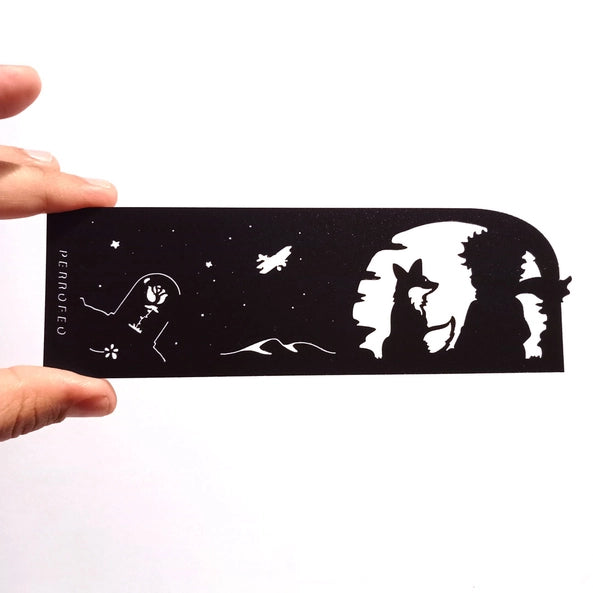 Marque-page découpé au laser en silhouette noire avec un jeune rêveur, un renard et un ciel étoilé