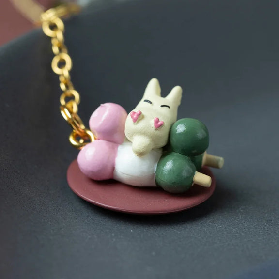 Porte-clés strap Totoro gris tenant un bol avec plateau de dango colorés, bijou de sac